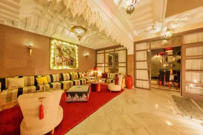 a living room with couches and a red rug at Riad Dar Arwa in Marrakech