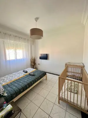 a bedroom with a bed and a staircase in it at Maison de ville avec piscine privée in Marrakech