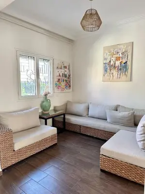 a living room with a couch and two chairs at Maison de ville avec piscine privée in Marrakech
