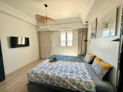 a bedroom with a bed with a teddy bear on it at Maison de ville avec piscine privée in Marrakech