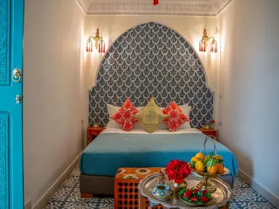 a bedroom with a bed and a table with fruit on it at Riad dada Messouda spa in Marrakech