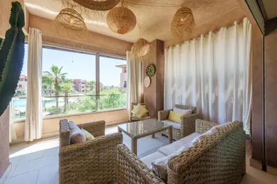 a living room with a couch and chairs and a large window at Stylish Bliss - Dream Apartment in Marrakech