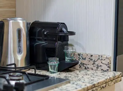 a counter top with a coffee maker and drinking glasses at Stylish Bliss - Dream Apartment in Marrakech