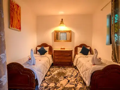 a bedroom with two beds with stuffed animals on them at Agréable Maison de vacances in Marrakech