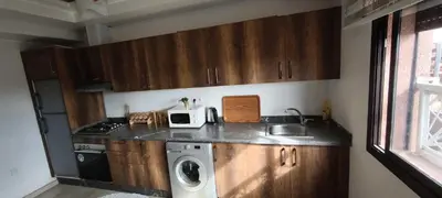 a kitchen with a sink and a washing machine at Appartement spacieux & lumineux à Gueliz in Marrakech