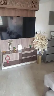 a living room with a large flat screen tv at Appartement spacieux & lumineux à Gueliz in Marrakech