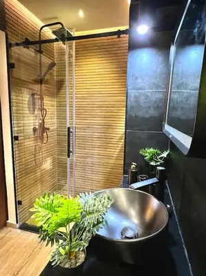a bathroom with a sink and a shower with plants at Appartement Marrakech Hivernage N37 RESIDENCE CAPRICE PALACE in Marrakech