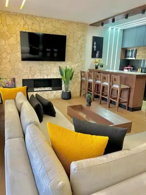 a living room with a white couch with yellow pillows at Appartement Marrakech Hivernage N37 RESIDENCE CAPRICE PALACE in Marrakech