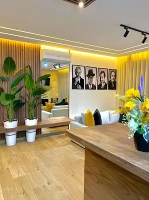a living room with a table and some plants at Appartement Marrakech Hivernage N37 RESIDENCE CAPRICE PALACE in Marrakech