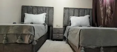 a bedroom with two beds withskirtsacersacers at Riad Aya in Marrakech