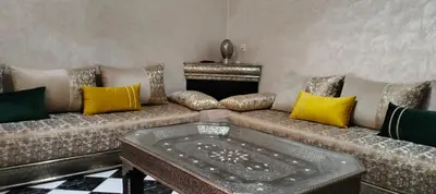 a living room with a couch with colorful pillows at Riad Aya in Marrakech