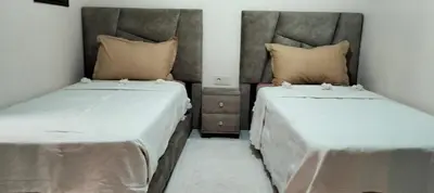 two beds sitting next to each other in a room at Riad Aya in Marrakech
