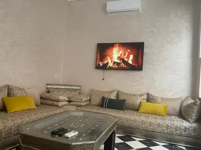 a living room with a couch and a fireplace at Riad Aya in Marrakech