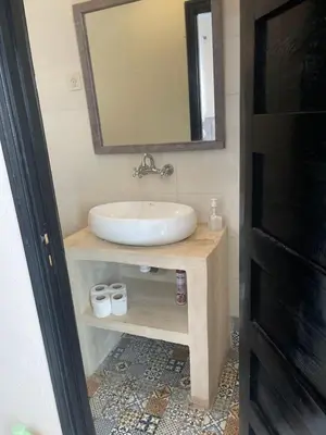 a bathroom with a sink and a mirror at Riad Aya in Marrakech