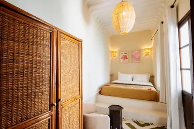 a bedroom with a bed and a large window at Riad Zi in Marrakech