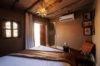 a bedroom with a large bed with a star on the ceiling at Riad Zi in Marrakech