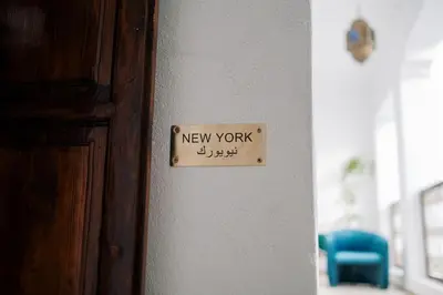 a new work sign on a wall next to a door at Riad Zi in Marrakech