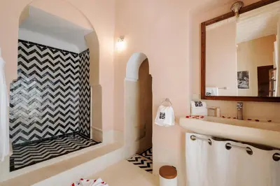 a bathroom with a sink and a mirror at Riad Zi in Marrakech