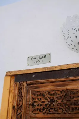 a sign on top of a wooden cabinet at Riad Zi in Marrakech