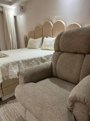a bedroom with a bed and a couch next to a chair at Luxueux Duplex 3 Chambres piscine,terrasse Hivernage Centre Marrakech in Marrakech