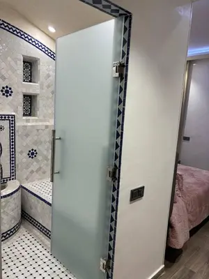a bathroom with a door open to a bedroom at Luxueux Duplex 3 Chambres piscine,terrasse Hivernage Centre Marrakech in Marrakech