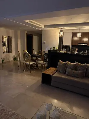 a living room with a couch and a dining room at Luxueux Duplex 3 Chambres piscine,terrasse Hivernage Centre Marrakech in Marrakech
