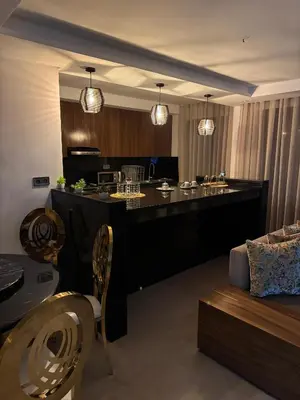 a living room with a large black bar with a couch at Luxueux Duplex 3 Chambres piscine,terrasse Hivernage Centre Marrakech in Marrakech