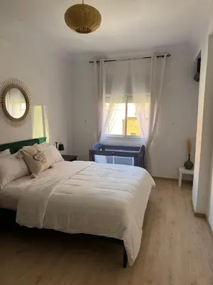 a bedroom with a large bed and a window at Appartement centre Marrakech gueliz - Cool & Cozy Apartment for a Family Stay in the Heart of the City in Marrakech