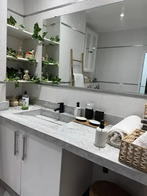 a kitchen counter with a sink and a mirror at Appartement centre Marrakech gueliz - Cool & Cozy Apartment for a Family Stay in the Heart of the City in Marrakech
