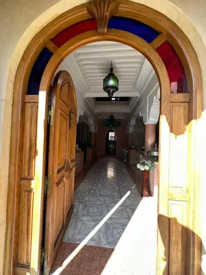 an archway leading into a building with a hallway at Riad malak in Marrakech