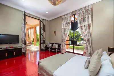 a bedroom with a bed and a large window at Domaine Marradise in Marrakech