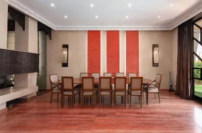 a dining room with a table and chairs at Domaine Marradise in Marrakech