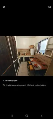 a picture of a kitchen with a table and a window at Riad Le Petit Cactus -Familial et Privatif- in Marrakech