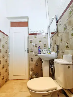 a bathroom with a toilet and a sink at Riad Le Petit Cactus -Familial et Privatif- in Marrakech