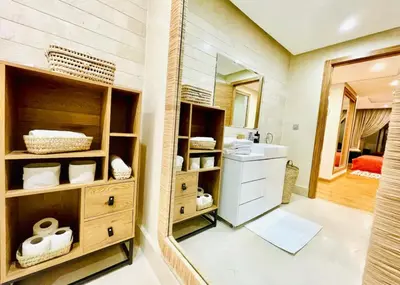 a bathroom with a sink and a mirror at Appartement luxueux avec vue panoramique sur l’Atlas au centre de Marrakech in Marrakech