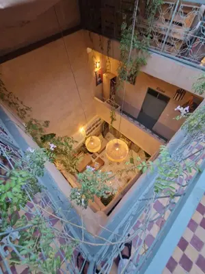 an overhead view of a room with tables and plants at Medina Oasis Hostel in Marrakech