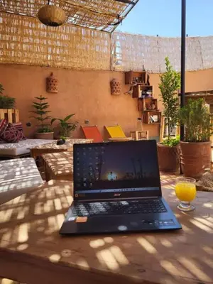 a laptop computer sitting on top of a table at Medina Oasis Hostel in Marrakech