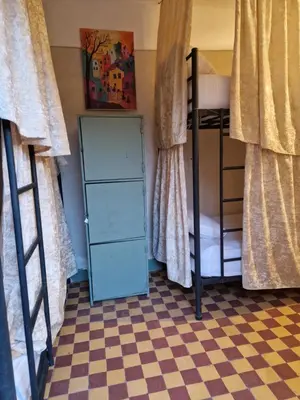 a bedroom with two bunk beds and a checkered floor at Medina Oasis Hostel in Marrakech