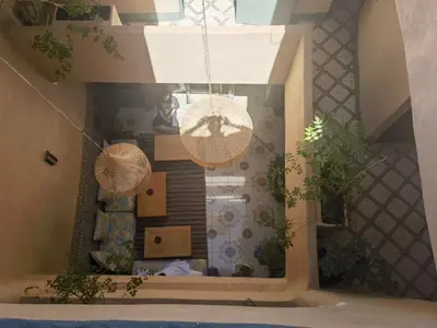 a rendering of a living room with a chandelier at Medina Oasis Hostel in Marrakech