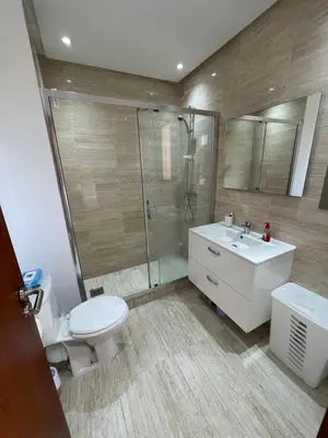 a bathroom with a toilet and a sink and a shower at Marrakech Prestigia 3 chambres in Marrakech