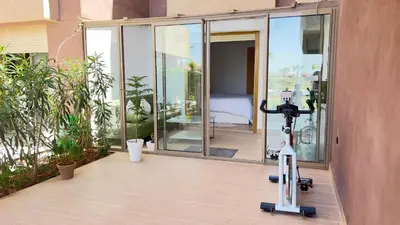 a camera is sitting on a balcony with a room at Appartement de Luxe avec Jardin Vue sur la Piscine Golf Securise 24h sur 24 a 5 Minutes de l Aeroport in Marrakech