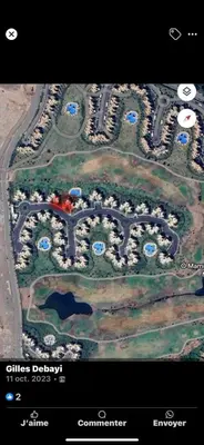 an aerial view of a parking lot with a city at Appartement de Luxe avec Jardin Vue sur la Piscine Golf Securise 24h sur 24 a 5 Minutes de l Aeroport in Marrakech
