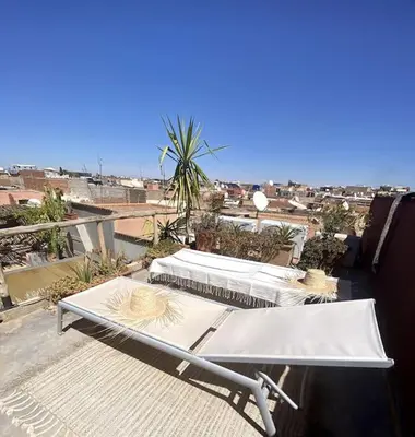 two beds on a balcony with a view of a city at Riad Kismet Marrakech in Marrakech
