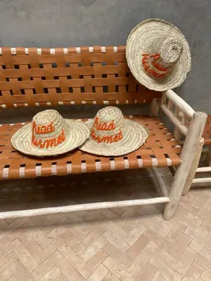 two hats sitting on top of a bench at Riad Kismet Marrakech in Marrakech