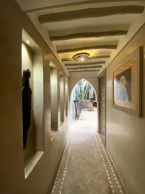 a hallway in a building with a painting on the wall at Riad Kismet Marrakech in Marrakech