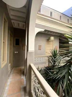 a porch of a house with a fence at Riad Kismet Marrakech in Marrakech