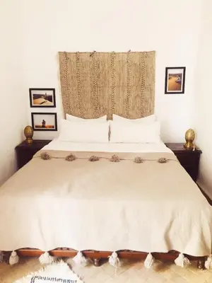 a bedroom with a large white bed with a window at NOSADE Venue in Marrakech