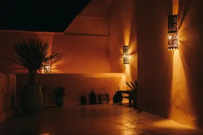 a hallway with two lights and a potted plant at NOSADE Venue in Marrakech