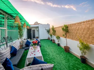 a patio with green grass and furniture on a building at Pretty Apartment in the Medina 2 in Marrakech