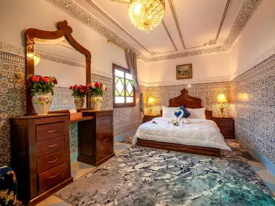 a bedroom with a bed and a large mirror at Pretty Apartment in the Medina 2 in Marrakech